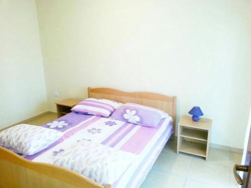 a bedroom with a bed with pink and white sheets at Apartment in Tribunj with terrace, air conditioning, WiFi 5038-2 in Tribunj