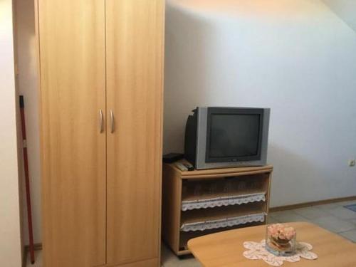 a living room with a television and a table at Apartment in Tribunj with terrace, air conditioning, WiFi 5038-4 in Tribunj