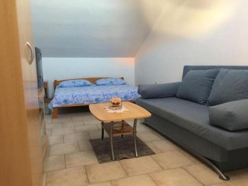 a living room with a couch and a table at Apartment in Tribunj with terrace, air conditioning, WiFi 5038-4 in Tribunj