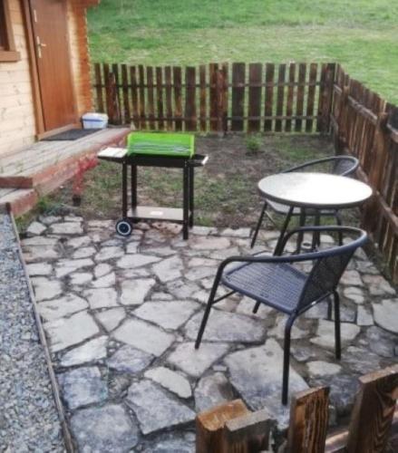 a patio with two tables and two chairs and a table at Dolina Rosy in Ustrzyki Dolne