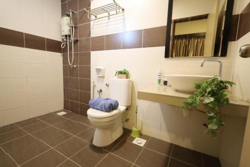 uma casa de banho com um WC e um lavatório em TOP 1 family trip relax resort in melaka pecuma water park tiket em Malaca