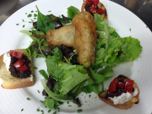 a plate of food with a salad and a sandwich at Giardino Di Sicilia in SantʼAgata di Militello