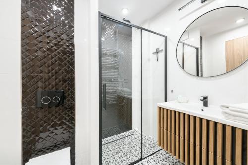 a bathroom with a shower and a sink at Happy Stay Comfort Apartment By the Beach in Sopot