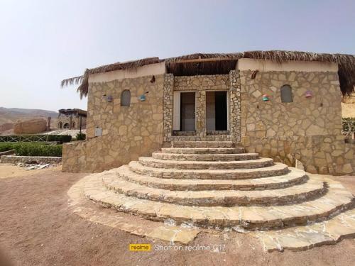 a stone building with steps in front of it at New Moon Island Camp in Nuweiba