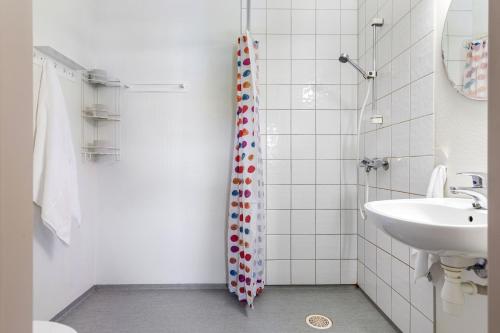 a bathroom with a shower and a toilet and a sink at Topcamp Mjøsa - Brumunddal in Brumunddalen