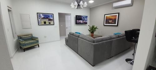 a living room with a couch and a chair at Bida Marino Residence Aruba in Palm-Eagle Beach