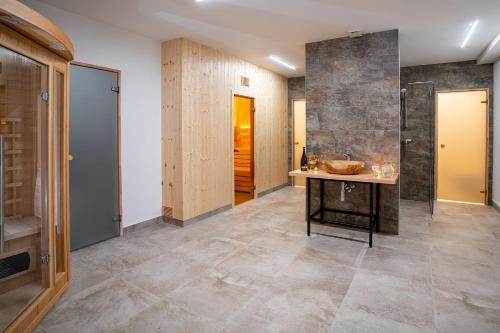 a bathroom with a sink and a walk in shower at Rezort pri jazere Podbanské in Pribylina