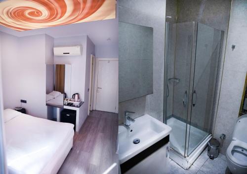 a bathroom with a bed and a shower and a sink at Park Çağlayan Hotel in Istanbul