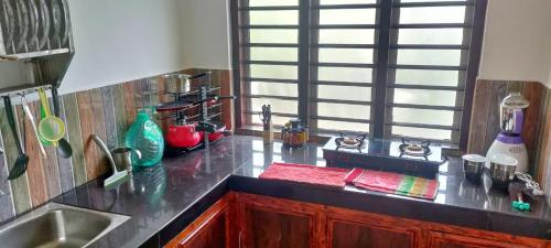 a kitchen with a sink and a counter top at Wayanad Days in Mananthavady