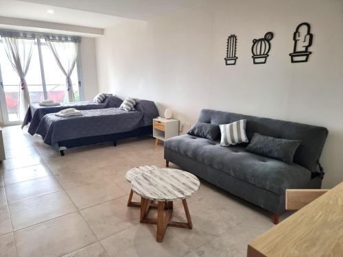 a living room with two couches and a table at Monoambiente San Martin in San Salvador de Jujuy