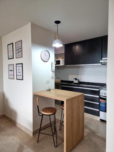 a kitchen with a wooden table and a chair at Monoambiente San Martin in San Salvador de Jujuy