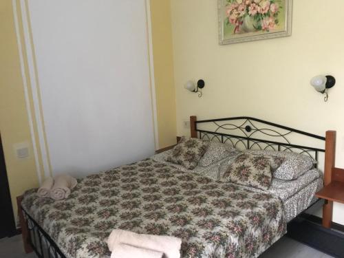 a bedroom with a bed with a floral bedspread at Villa Galicia in Berehove