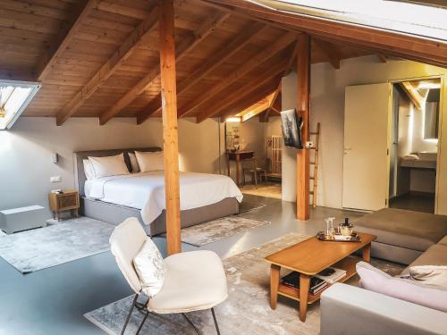 a bedroom with a bed and a living room at API Projects Nafplio - Superior Loft in Nafplio