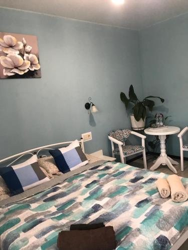 a bedroom with a bed and a table and chairs at Villa Galicia in Berehove