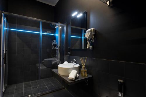 a bathroom with a sink and a glass shower at Love Suite Roma - Il Nido d'Amore in Rome