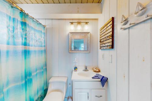 a bathroom with a sink and a bath tub and a mirror at Edgewater Acres --- 39167 Garfield Avenue in Selbyville