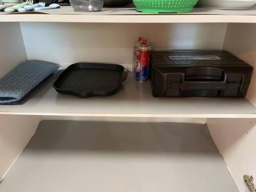 a shelf with a printer and a can of soda at Peaceful North Lakes Haven w A Touch of Zen in North Lakes
