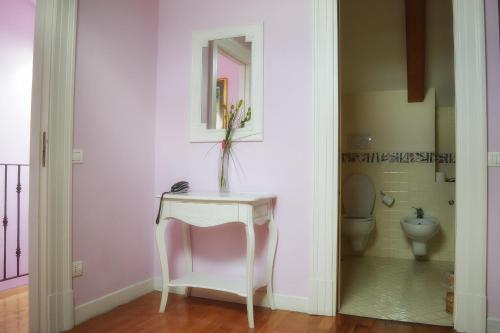 a bathroom with a white table and a toilet at The Secret Garden Relais in Piano di Sorrento