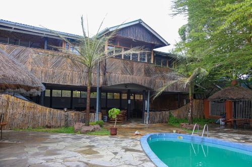 a house with a swimming pool in front of it at Naivasha Peppercorn Holiday Resort in Naivasha