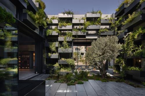 an image of an apartment building with a courtyard at Minthis Resort in Paphos City