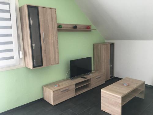 a living room with a flat screen tv on a wall at Ferienwohnung Ludwig in Karlstadt