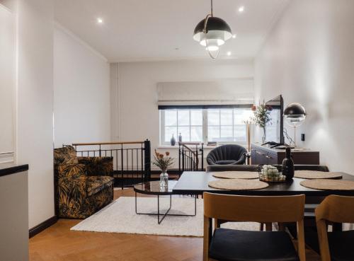 a living room with a table and chairs and a couch at Bob W Koti Katajanokka in Helsinki