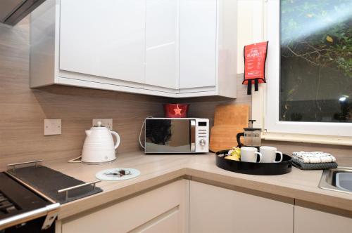 a kitchen with a counter top with a microwave at Pedals and Paddles in Innellan