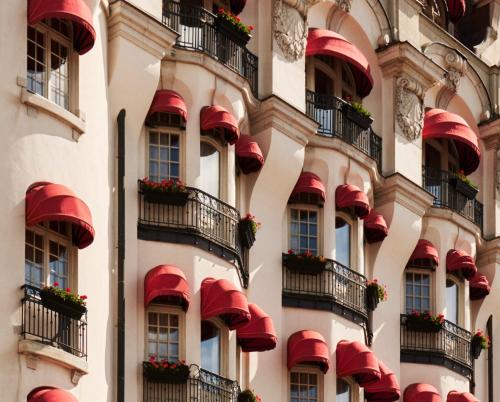 a facade of a building with red balconies and flowers at Hotel Diplomat Stockholm in Stockholm