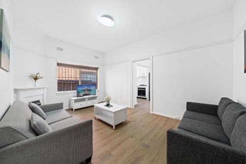 a living room with two couches and a tv at Burwood New 2 Bedroom 2 Bath Apt Free Parking in Sydney