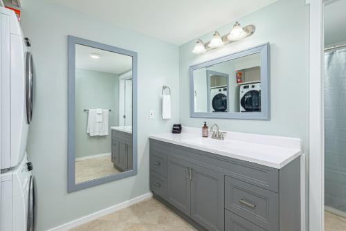 a bathroom with a sink and a mirror at The Alpine - Central Collingwood Condo in Collingwood