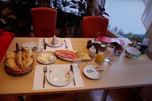 a table with plates of food on top of it at Gertis Blumenhof Privatzimmer, Ferienwohnung in Gmünd