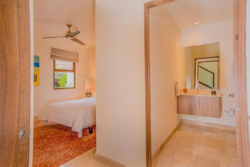 a bedroom with a bed and a mirror at Aromo TH3 Townhouse with private pool Reserva Conchal in Playa Conchal