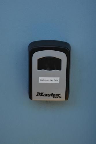 a black and white toaster sitting on a blue surface at Baltica Beach House in Culburra Beach