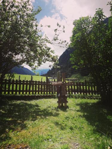 a wooden fence in the middle of a field at Schiederhof in Mittersill