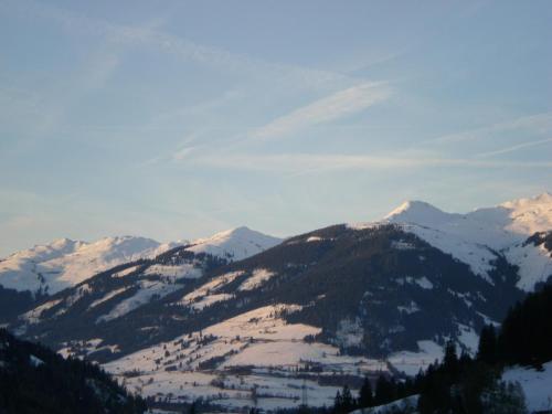 a snow covered mountain range with snow covered mountains at Schiederhof in Mittersill