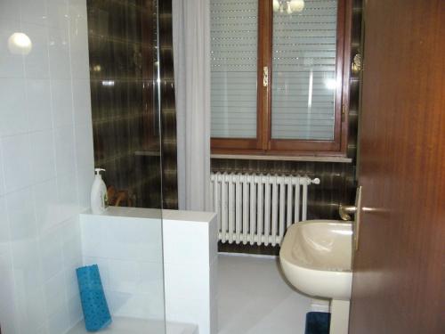 a bathroom with a white toilet and a sink at Casa Berti in Spello