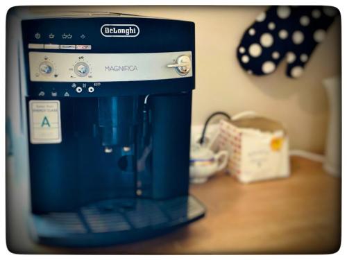 a blue coffee maker sitting on top of a table at Vila Montana Valiug in Văliug