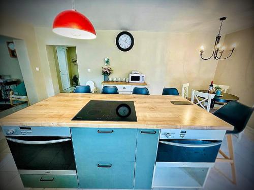 a kitchen with a wooden counter top and a table at Vila Montana Valiug in Văliug
