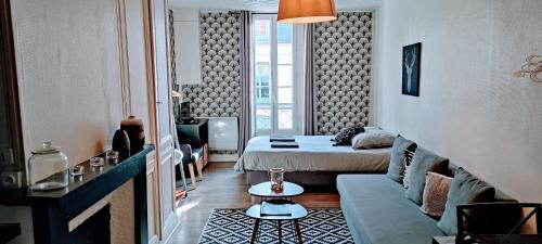 a small room with a bed and a couch at 3 Emplacement Parfait ! 150m de la mer et de la rue Piétonne in Dieppe