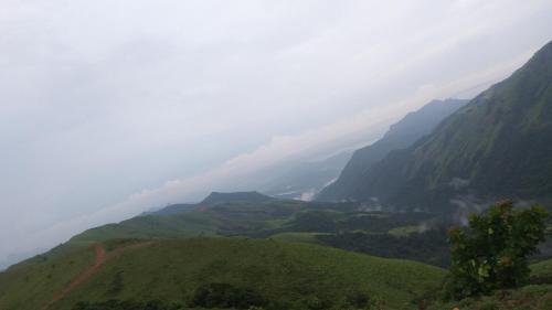a view of a mountain valley in the clouds at Sirimane Homestay - Swimming Pool, Food, Near to Falls & Trek in Sakleshpur