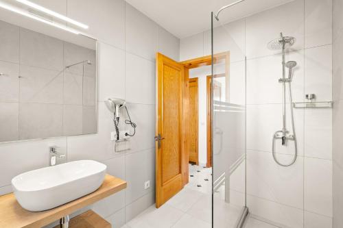 a bathroom with a sink and a shower at Torres Sureda in Cala Blanca