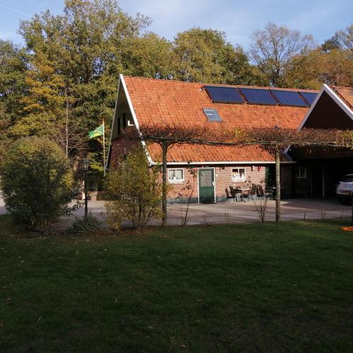 a house with a roof with solar panels on it at Veenemaat in Winterswijk