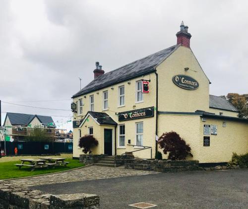 a white building with a sign on the front of it at Modern Homestay 15 minutes to Dublin Airport in Ballyboughal
