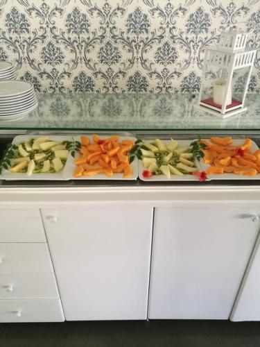 two trays of vegetables on top of a counter at Resort Sciabache in Zambrone