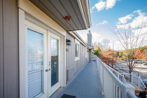 a walkway leading to a building with a door at The Alpine - Central Collingwood Condo in Collingwood