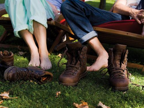 a couple of people with their shoes on the grass at Landhaus Benediktenhof in Bad Tölz