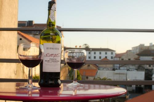 a glass of wine sitting on top of a table at Apartments Porto Historico in Porto