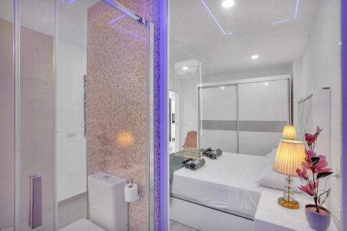 a white bathroom with a sink and a shower at LAS AMERICAS BEACH, 2 Bedrooms, Fiber, Pool in Playa de las Americas