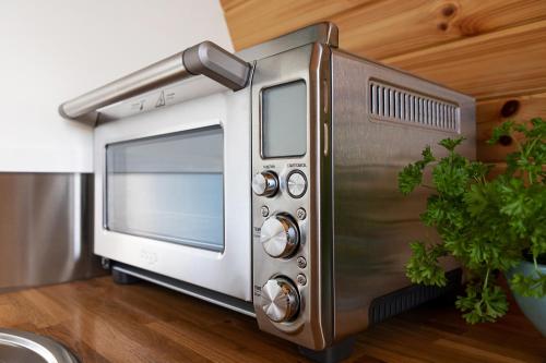 a silver toaster oven sitting on a kitchen floor at High Longlands in Cartmel