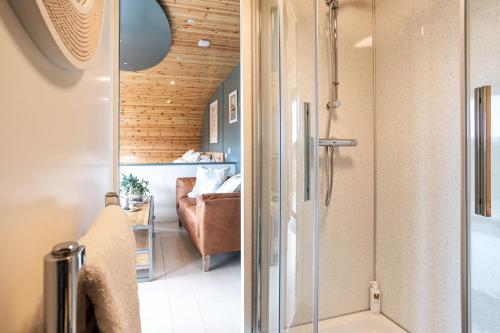 a bathroom with a shower and a bedroom at High Longlands in Cartmel